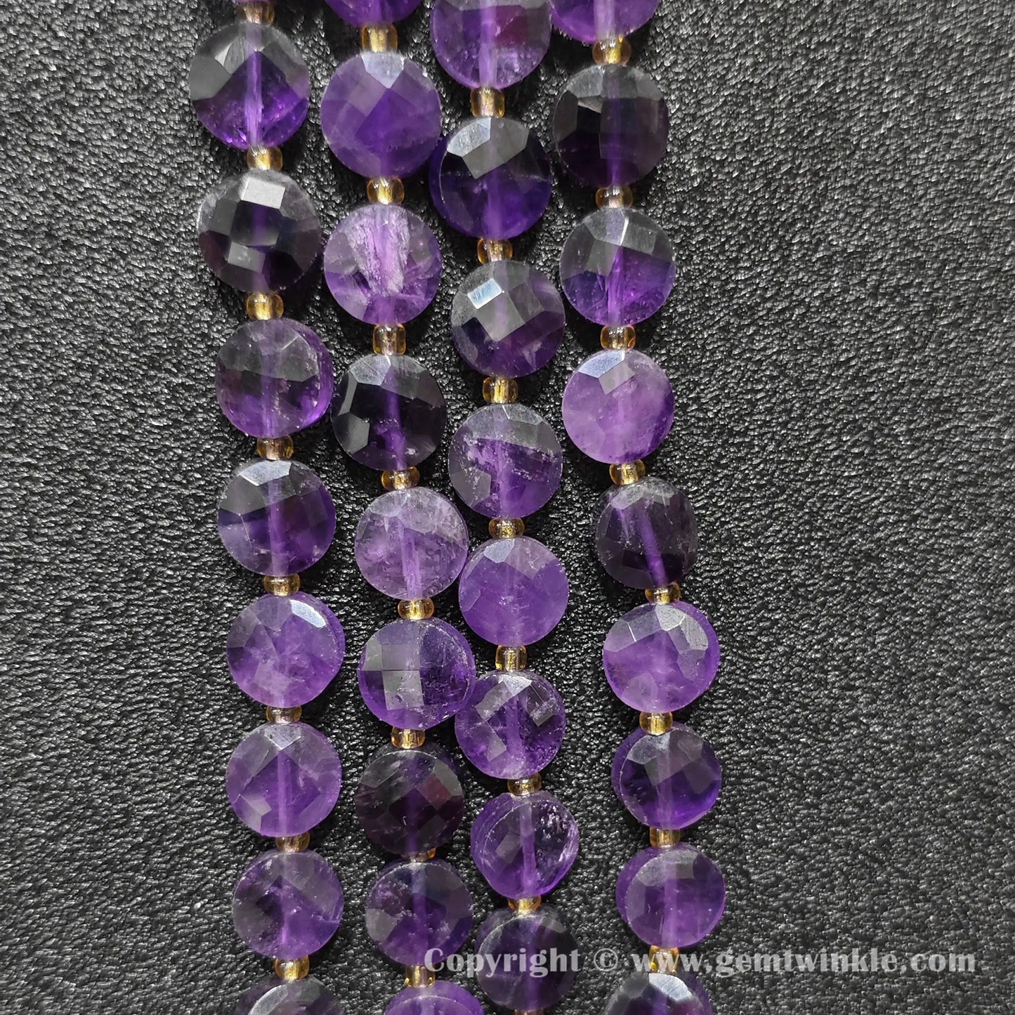 Side view of purple amethyst faceted flat disc beads displaying bead thickness