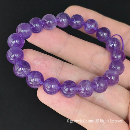 top view of purple amethyst round bead stretch bangle on hand