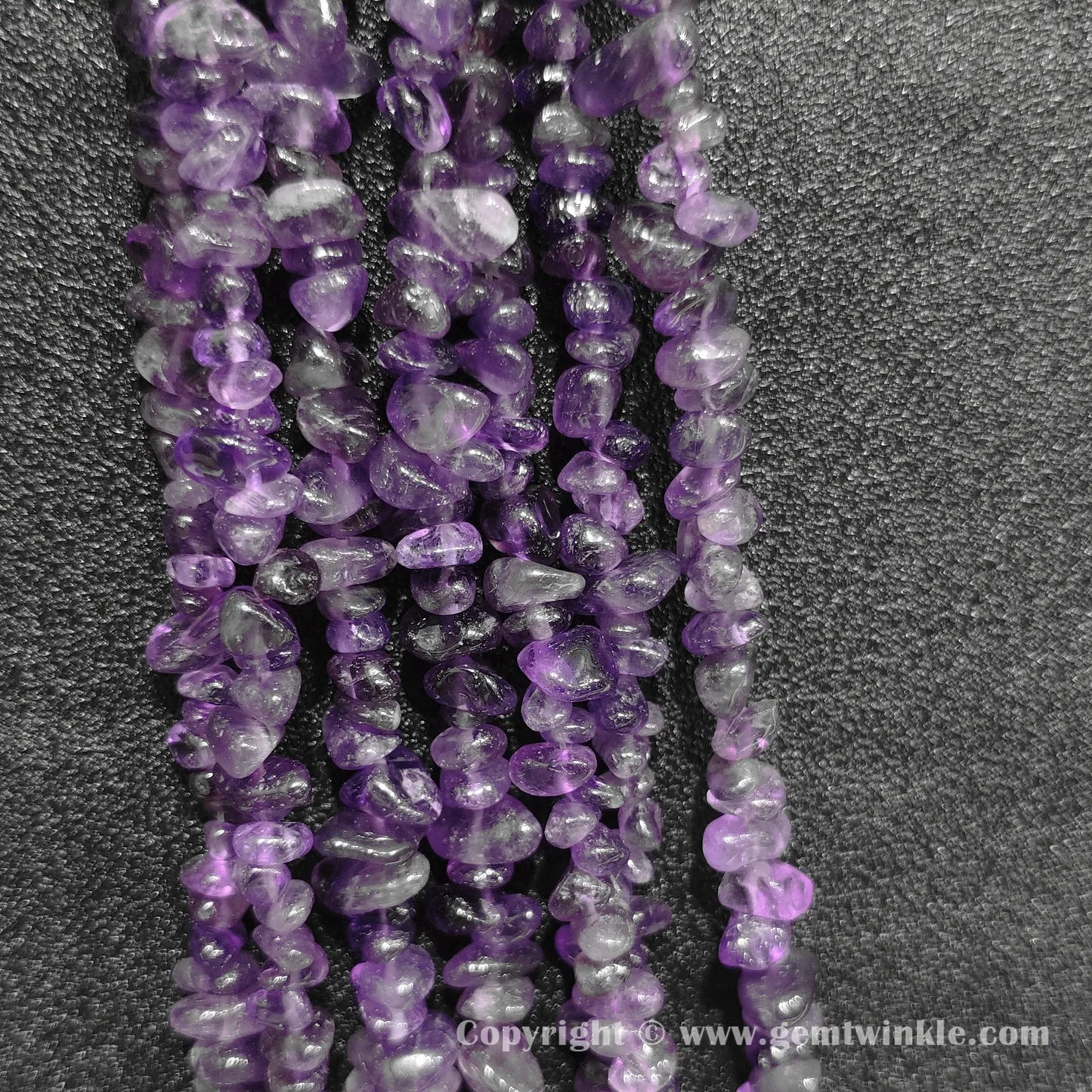 Close up view of tumbled purple amethyst freeform nugget chip beads