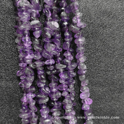 Close up view of tumbled purple amethyst freeform nugget chip beads