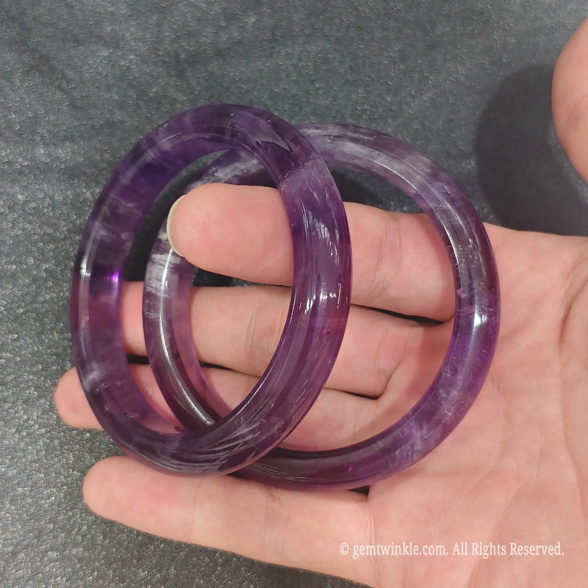 Natural Amethyst bangles held together demonstrating unique natural quartz veins and rich purple hue