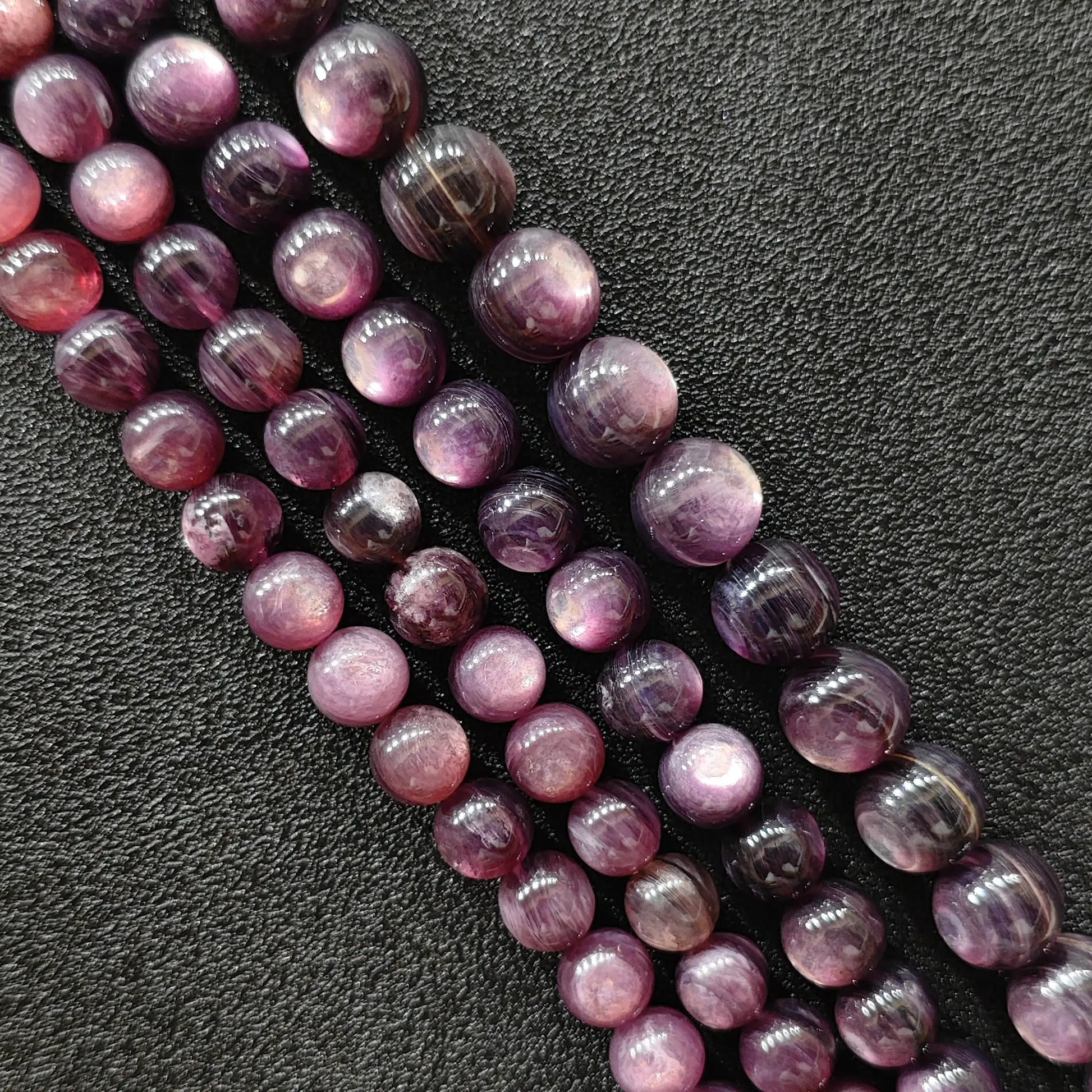 Purple lepidolite crystal beads strands showing shimmering lavender hues and layered mica textures