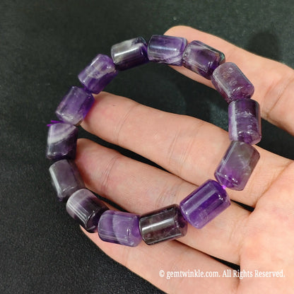 purple amethyst barrel bead elastic bracelet displayed on hand featuring white quartz lines