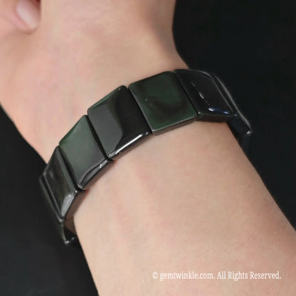 Rainbow obsidian curved rectangular plate stretch bracelet styled on wrist showing smooth cuff profile