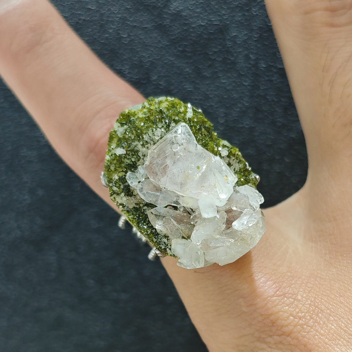Raw epidote crystal cluster adjustable open ring worn on hand close up showing green matrix and white crystals