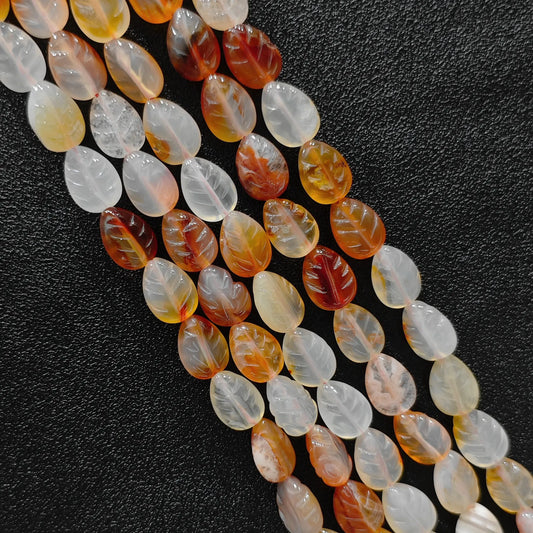 Macro closeup of red agate leaf carved beads 14mm showing color-dyed smooth polish