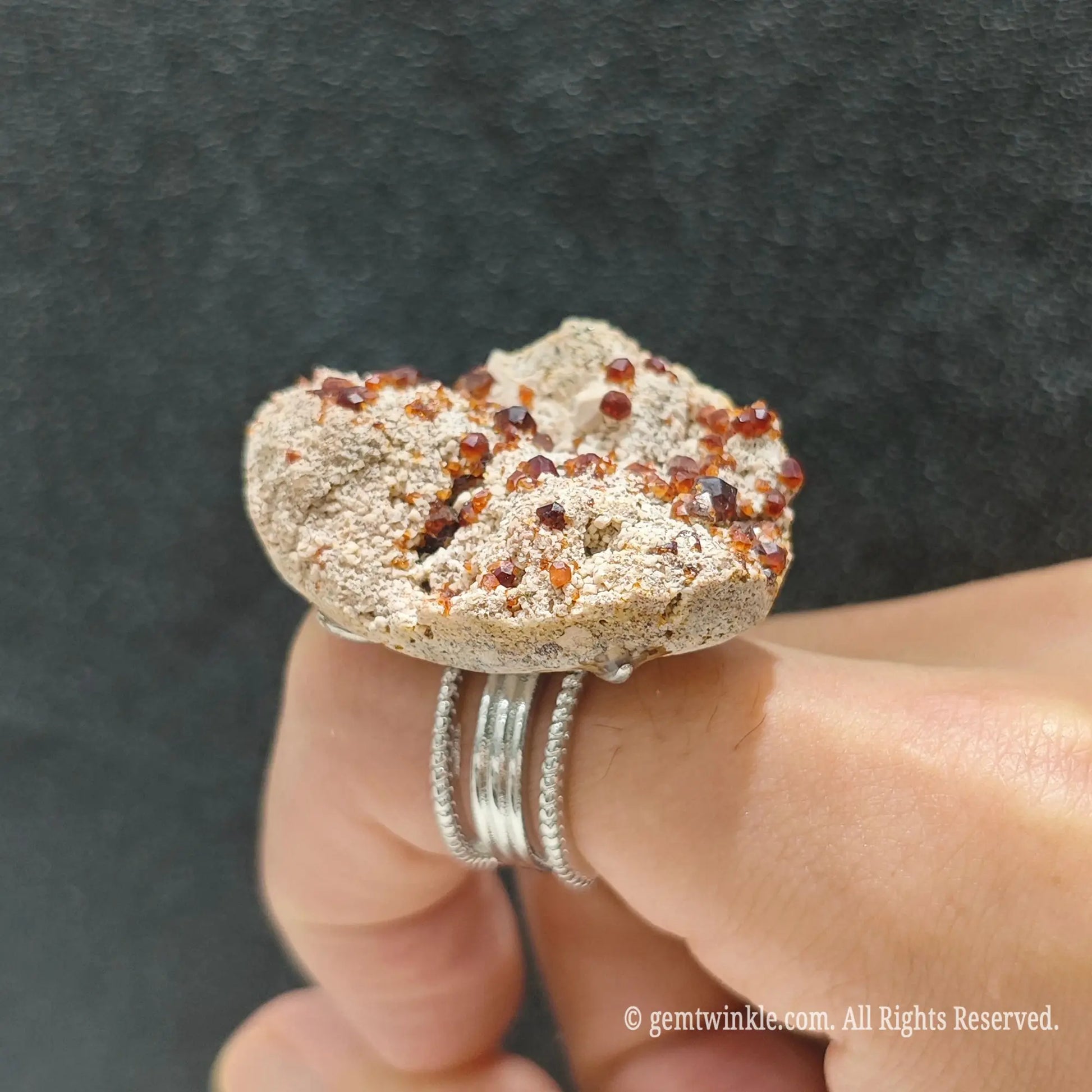 Red garnet crystal matrix statement ring top view on finger displaying 25-35mm raw mineral slice formation