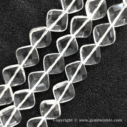 Close up view of faceted rhombus slice clear quartz beads showing light reflections