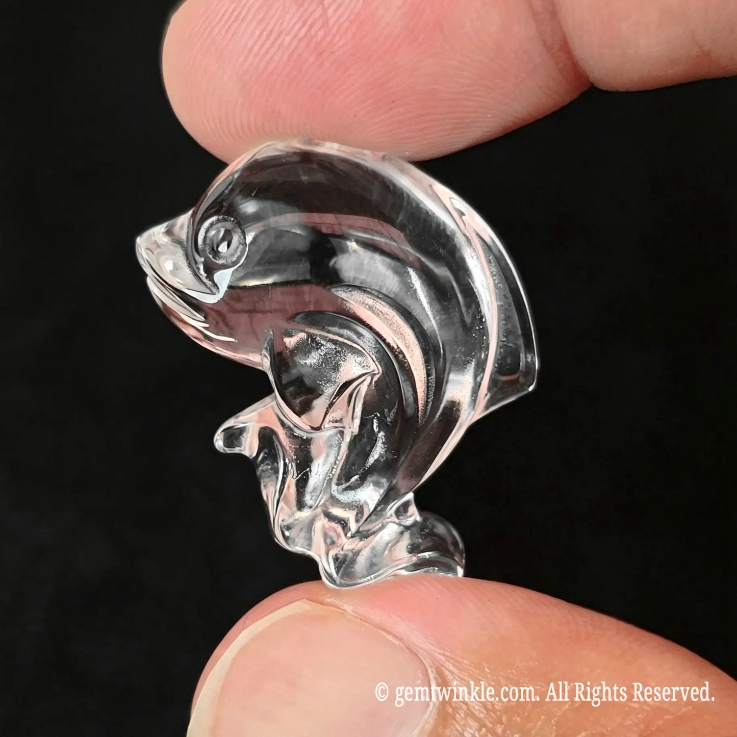 Side view of 30mm clear quartz dolphin showing smooth polished dorsal fin and body clarity