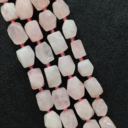 close up view of translucent pastel pink quartz geometric cylinder beads