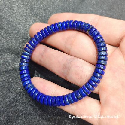 Close up perspective of lapis lazuli disc beads highlighting rich ultramarine color and natural pyrite specks