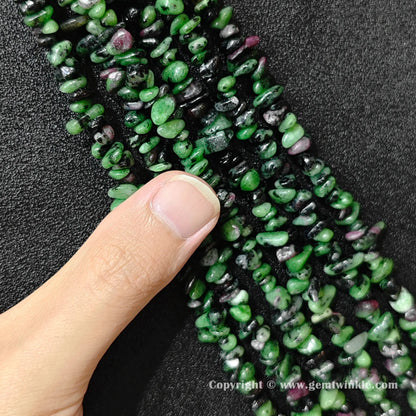 Natural ruby zoisite chip bead strand held over hand showing 80cm strand scale