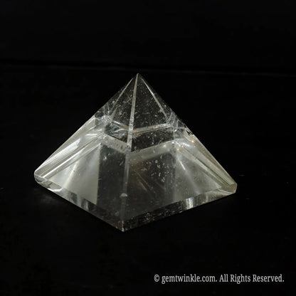Top-down view of a clear quartz pyramid detailing the beveled polished edges and included crystal body