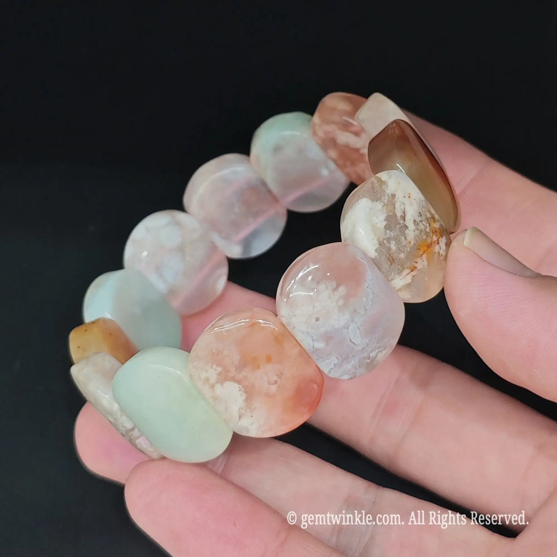 Full view of sakura blossom agate 20x15mm block stretch bracelet resting in hand showcasing varied pastel beads