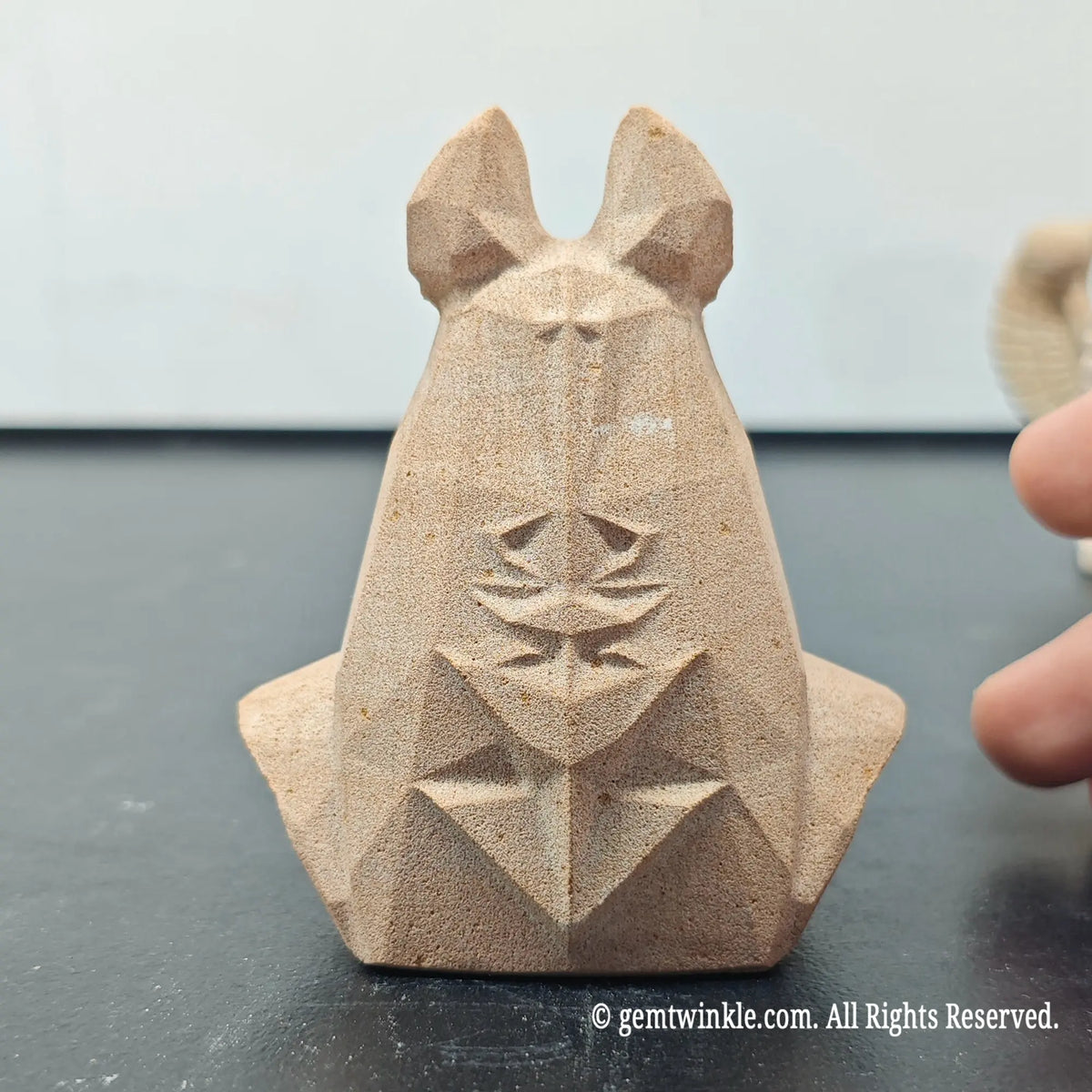 back profile of natural sandstone anubis bust sculpture displaying carved scarab beetle emblem