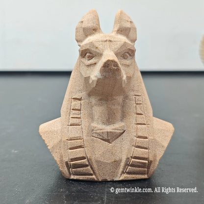 front view of natural sandstone carved egyptian anubis jackal god bust figurine showing geometric matte finish