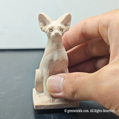 front view of natural sandstone egyptian bastet cat figurine displaying alert ears and facial features