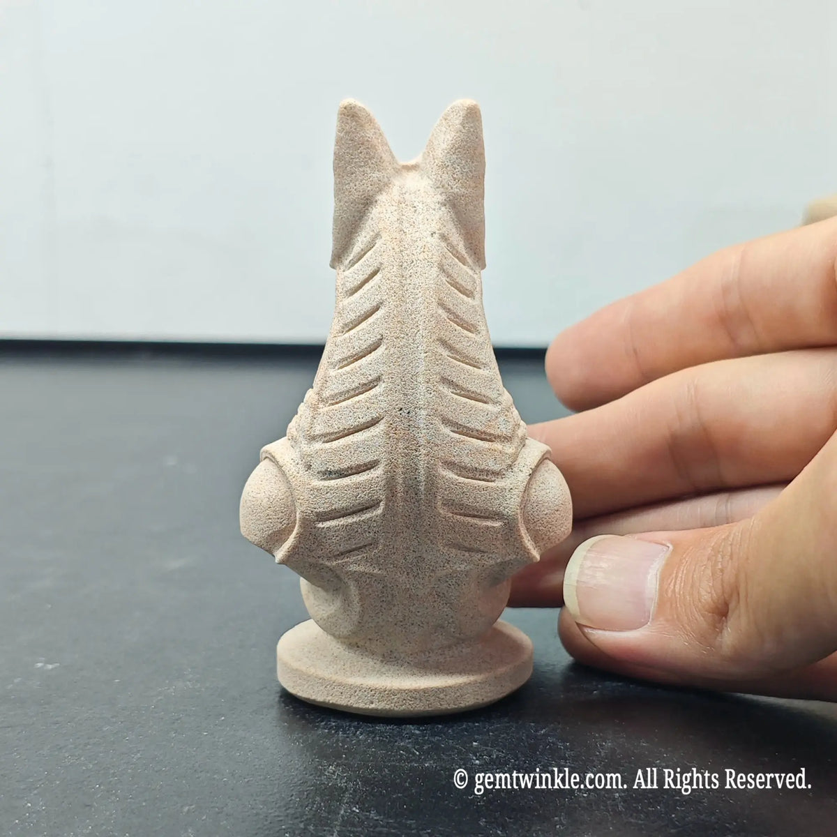 back profile of natural sandstone carved anubis bust sculpture showing detailed headcloth lines