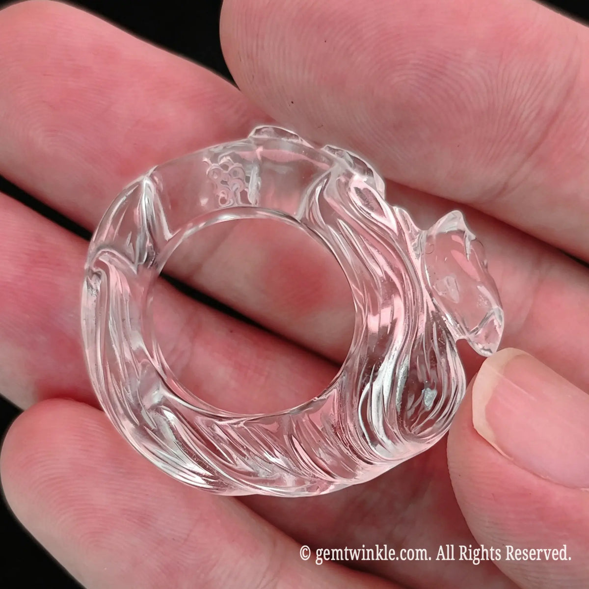 Top angle view of carved clear quartz fox ring showing inner band diameter and polished contours