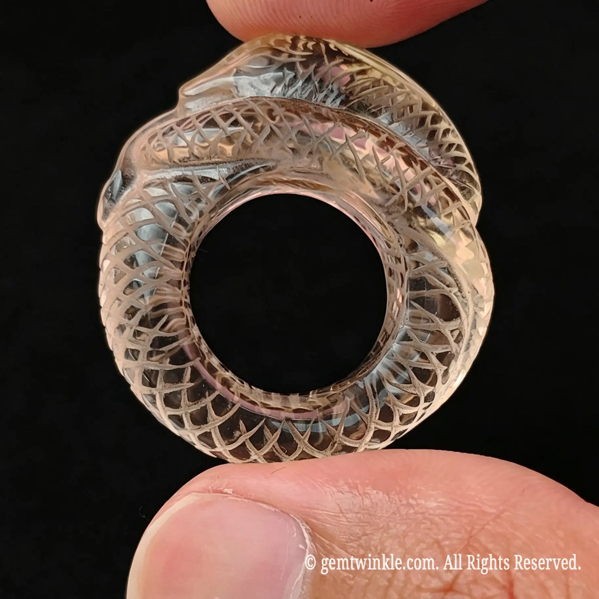 Top view of carved lemon quartz snake ring showing smooth inner band diameter and coiling body