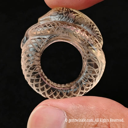 Top view of carved lemon quartz snake ring showing smooth inner band diameter and coiling body