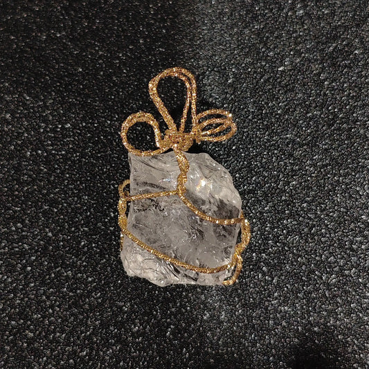 Semi-translucent clear quartz rough stone wrapped in gold-tone craft wire with looped top bail