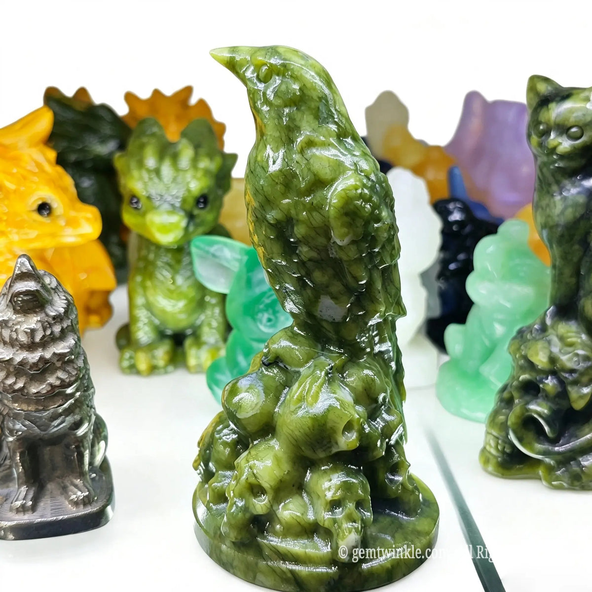 Rear side view of serpentine crow figurine highlighting carved feather textures and dark green mineral luster