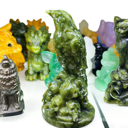 Rear side view of serpentine crow figurine highlighting carved feather textures and dark green mineral luster