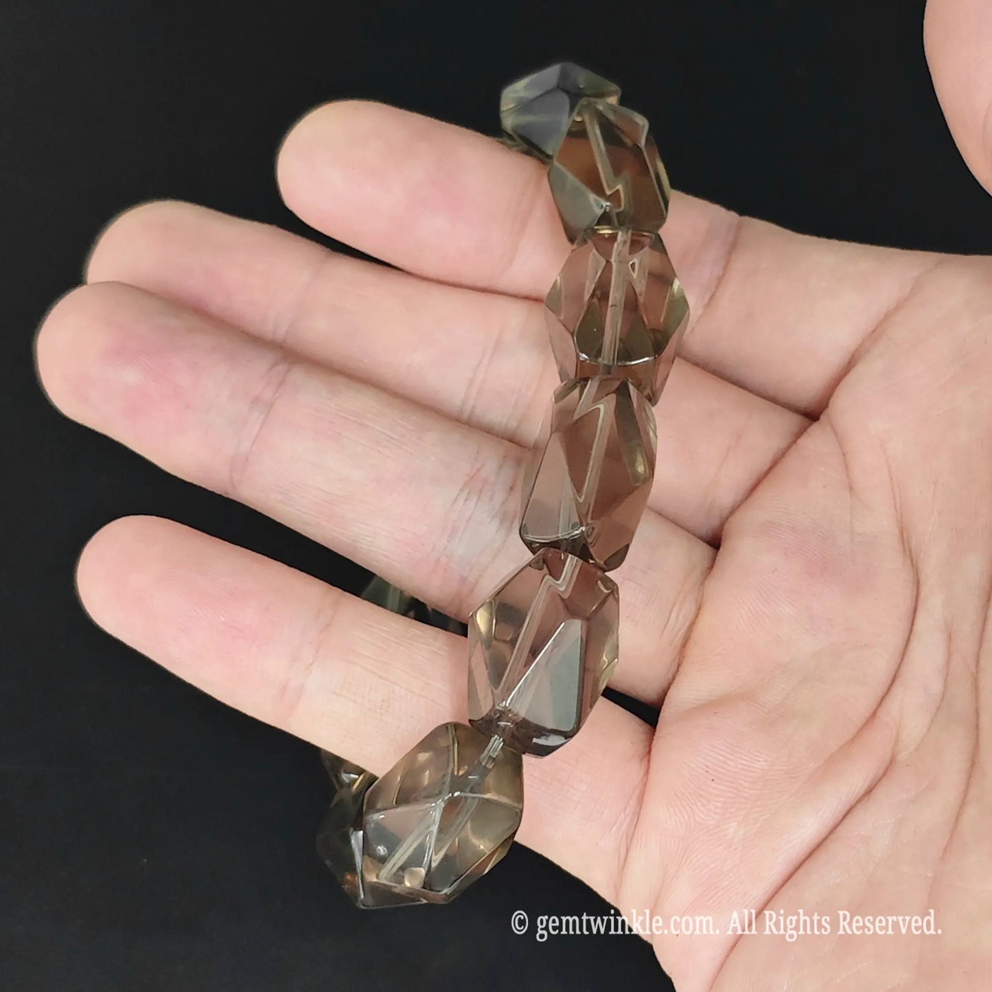 top view of tea quartz faceted freeform bead stretch bangle on hand