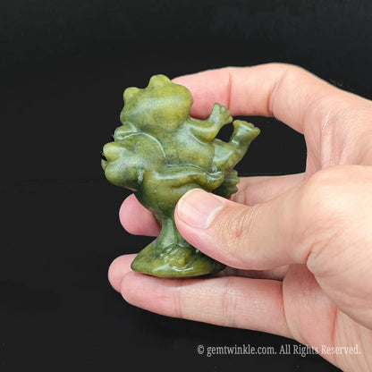 Close up of a silly serpentine frog lovers anniversary mascot showing the polished hand carved details of the amphibian couple