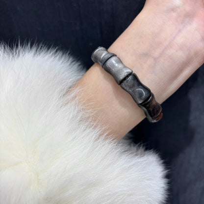 Wrist shot of the Natural Silver Sheen Obsidian Bamboo Bead Bracelet, showing how it looks when worn as a single or stacked layer.