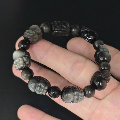 hand holding silver sheen obsidian carved pixiu beads stretch bracelet