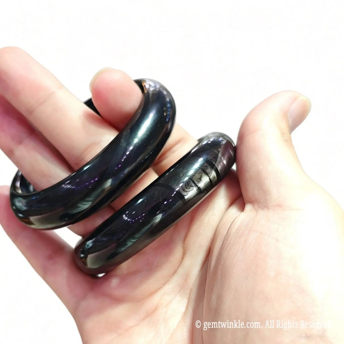 Pair of silver sheen hypersthene wristbands showing custom inner diameter sizing and price tiers
