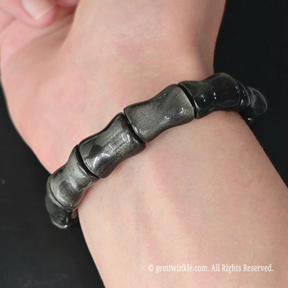 Silver sheen obsidian 16mm bamboo joint carved bracelet styled on wrist showcasing comfortable inner fit