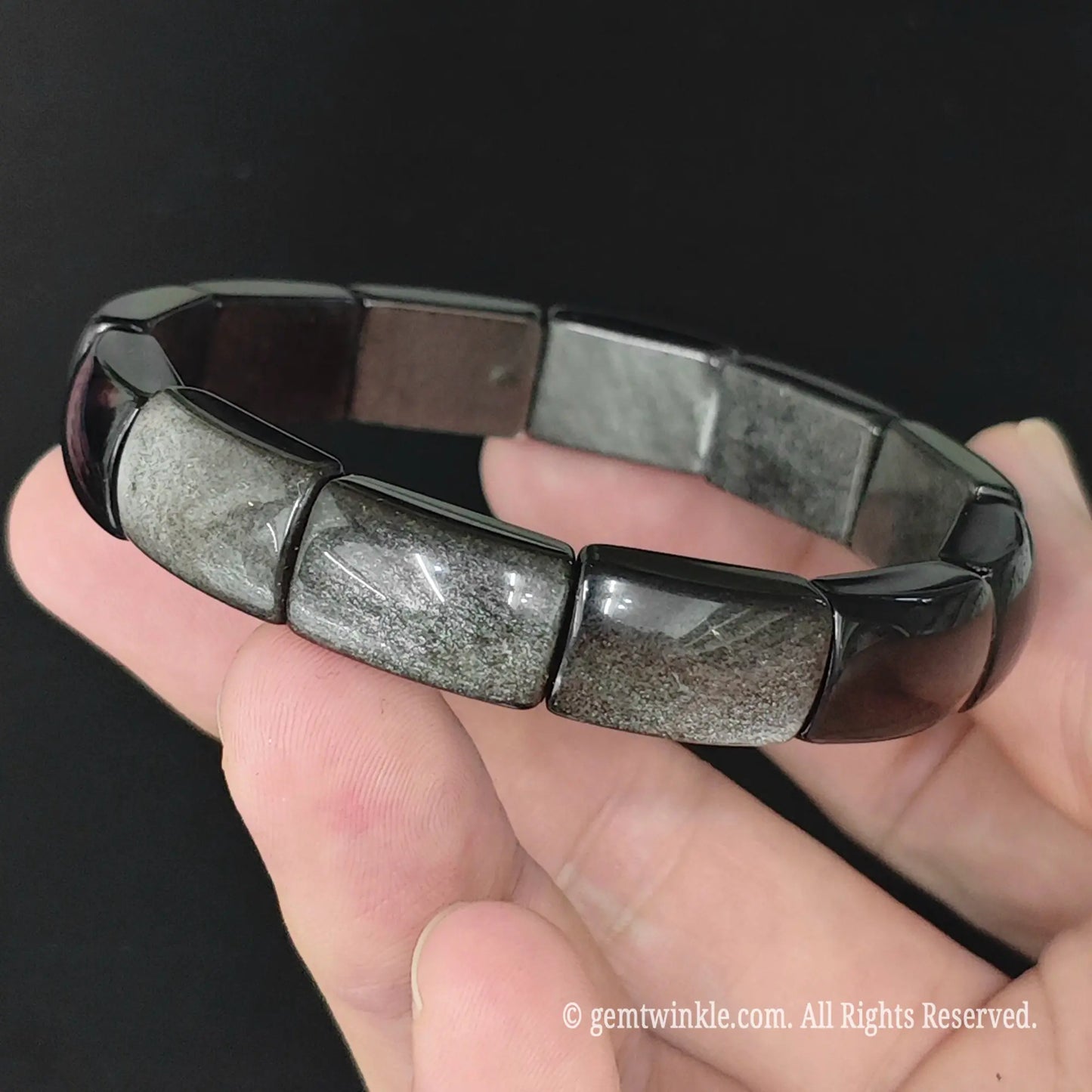 Side view of silver sheen obsidian curved plate cuff bracelet displaying polished metallic silver sheen