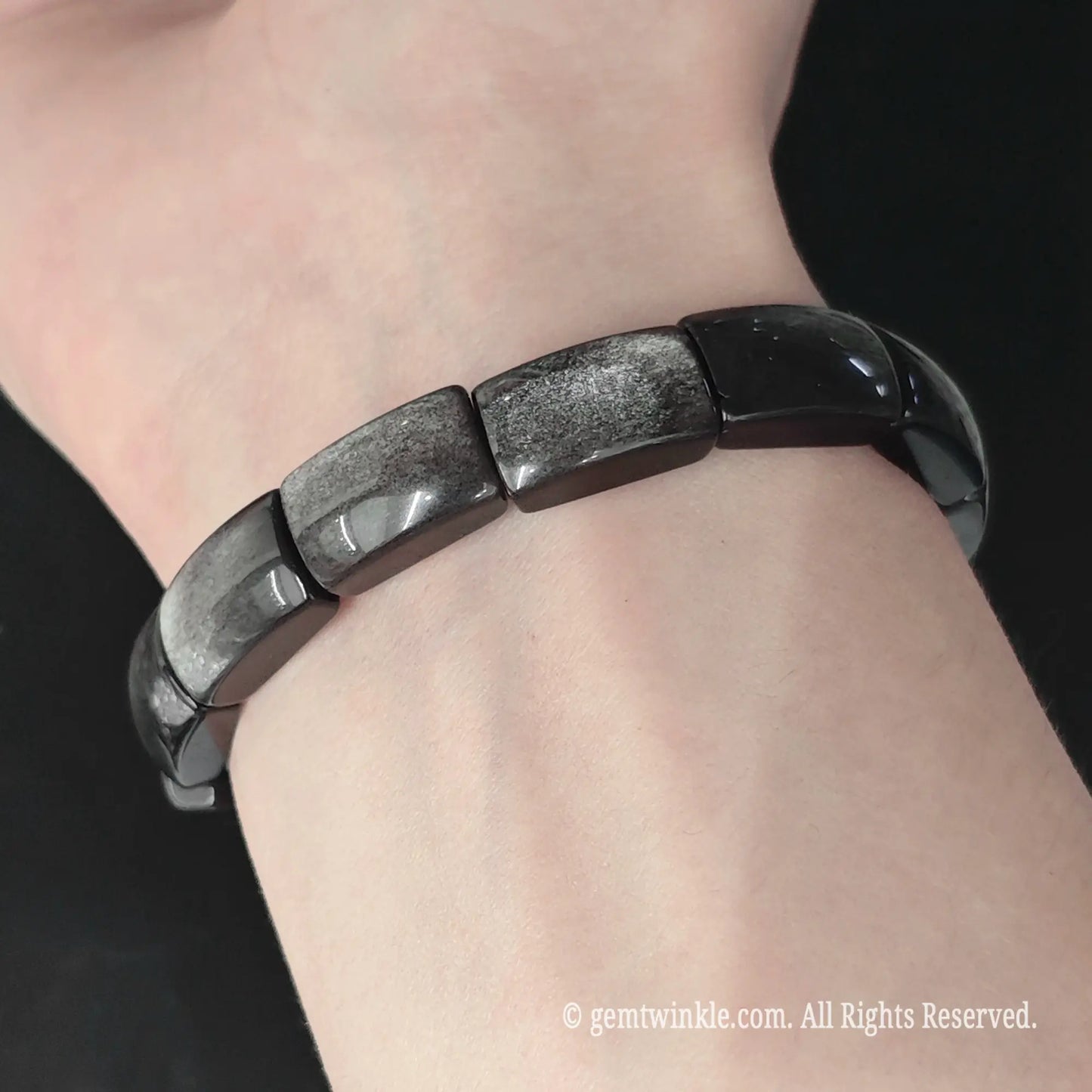 Silver sheen obsidian rectangle plate stretch bracelet worn on wrist showcasing smooth curved bead profile