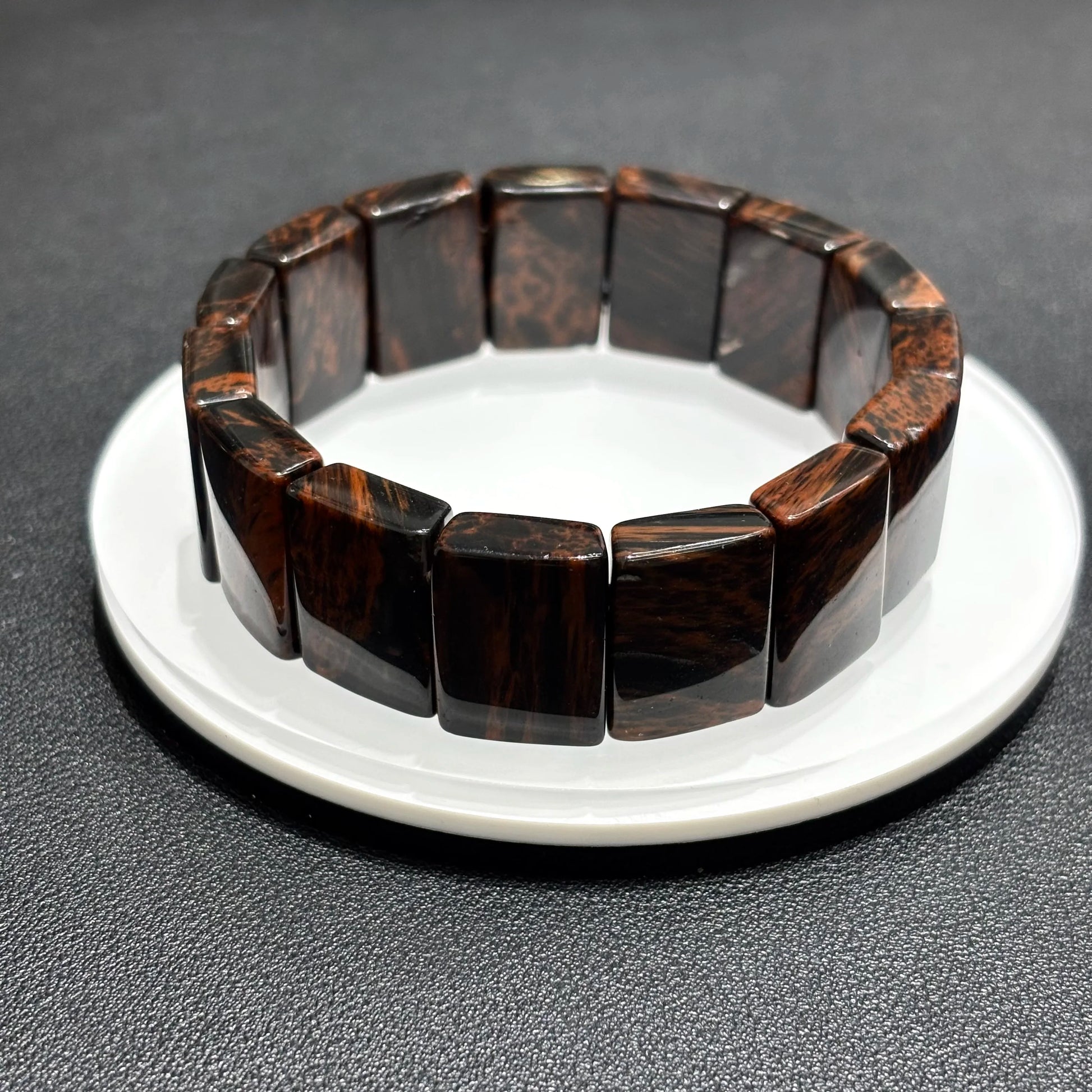 Single Natural Mahogany Obsidian Bangle Bracelet on White Plate, Rectangular Bead Design, 18.5cm Length, Meditation Tool