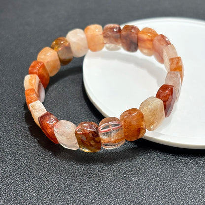 A single red hematoid fire quartz bangle bracelet displayed on a white plate, showcasing the rectangular beads.