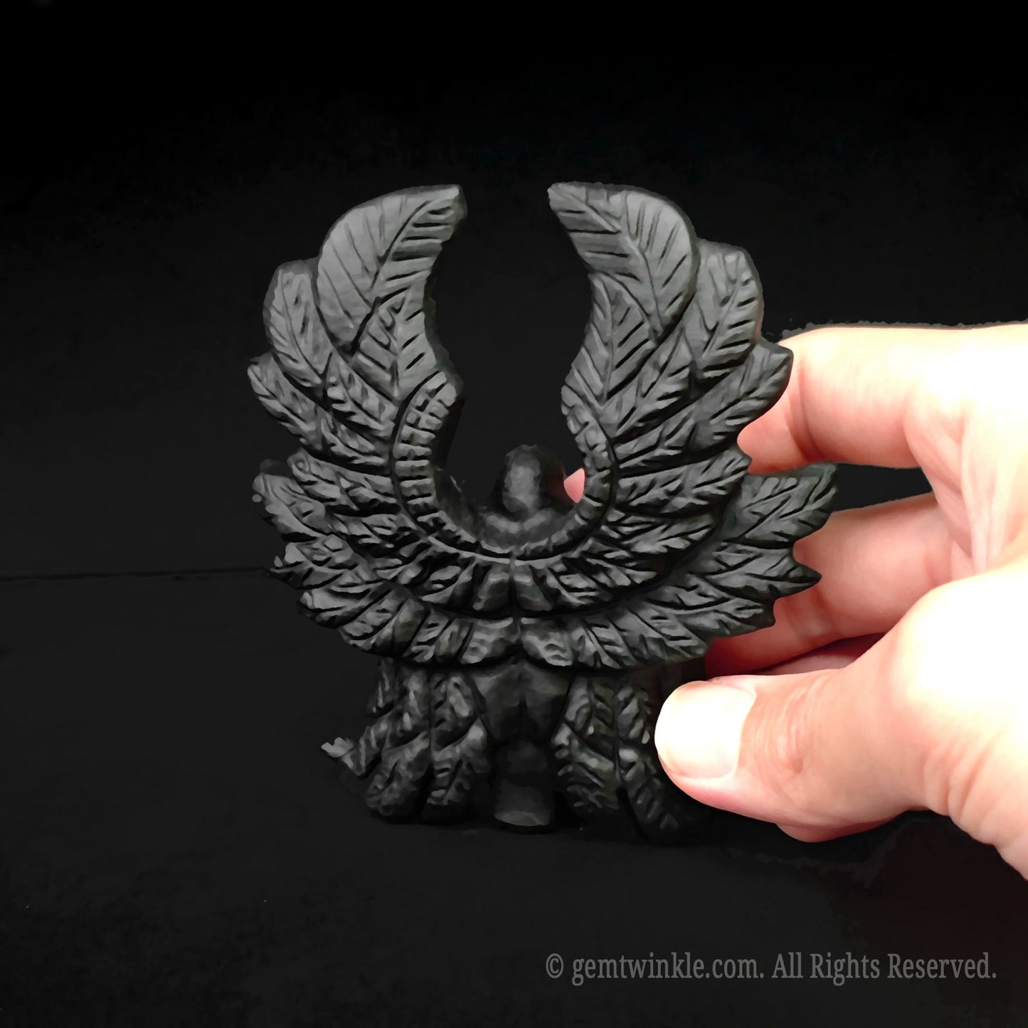 Intricate layered wing details on the back of the hand sculpted black obsidian six winged angel figurine