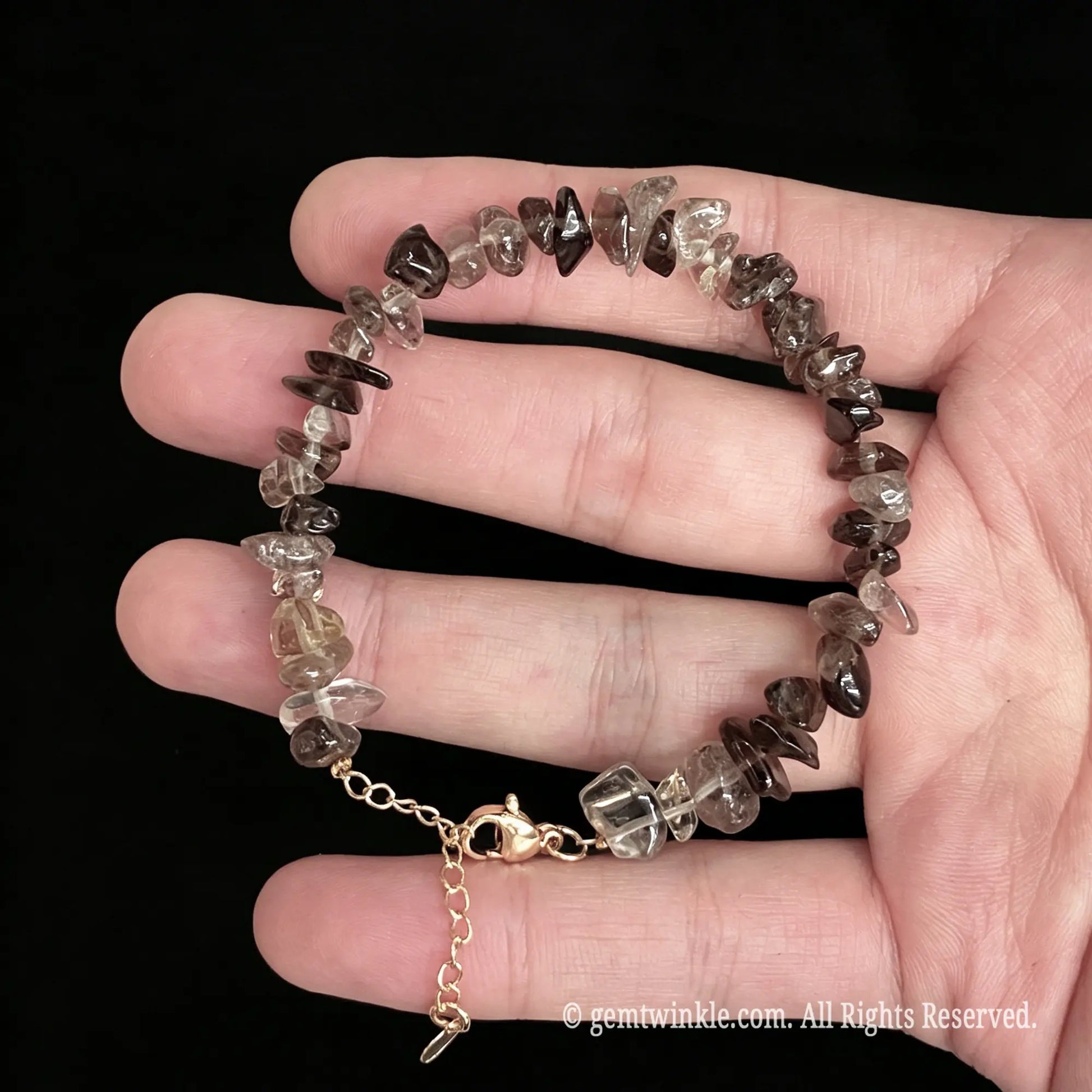 detail view of gold tone alloy extender chain and clasp on smoky quartz bracelet