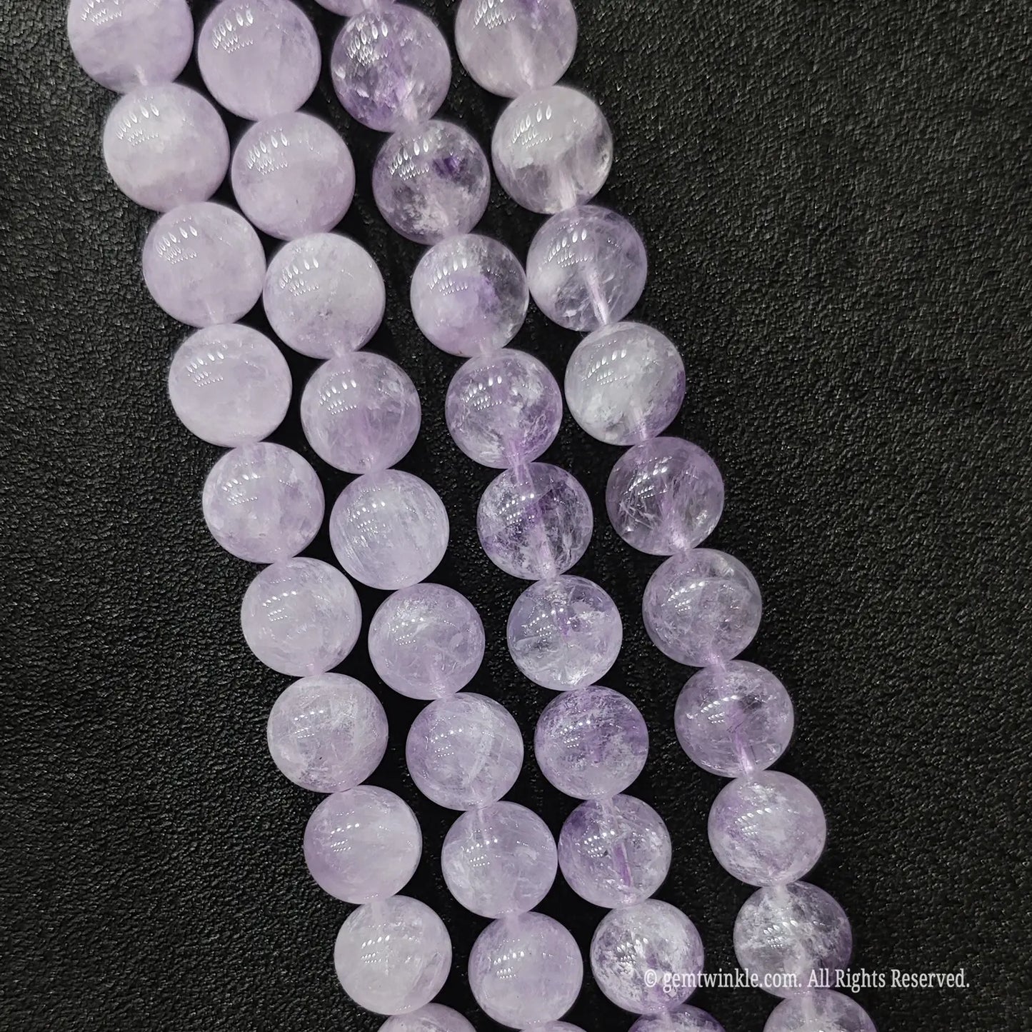 Three strands of soft purple lavender amethyst crystal beads showcasing delicate milky translucent texture