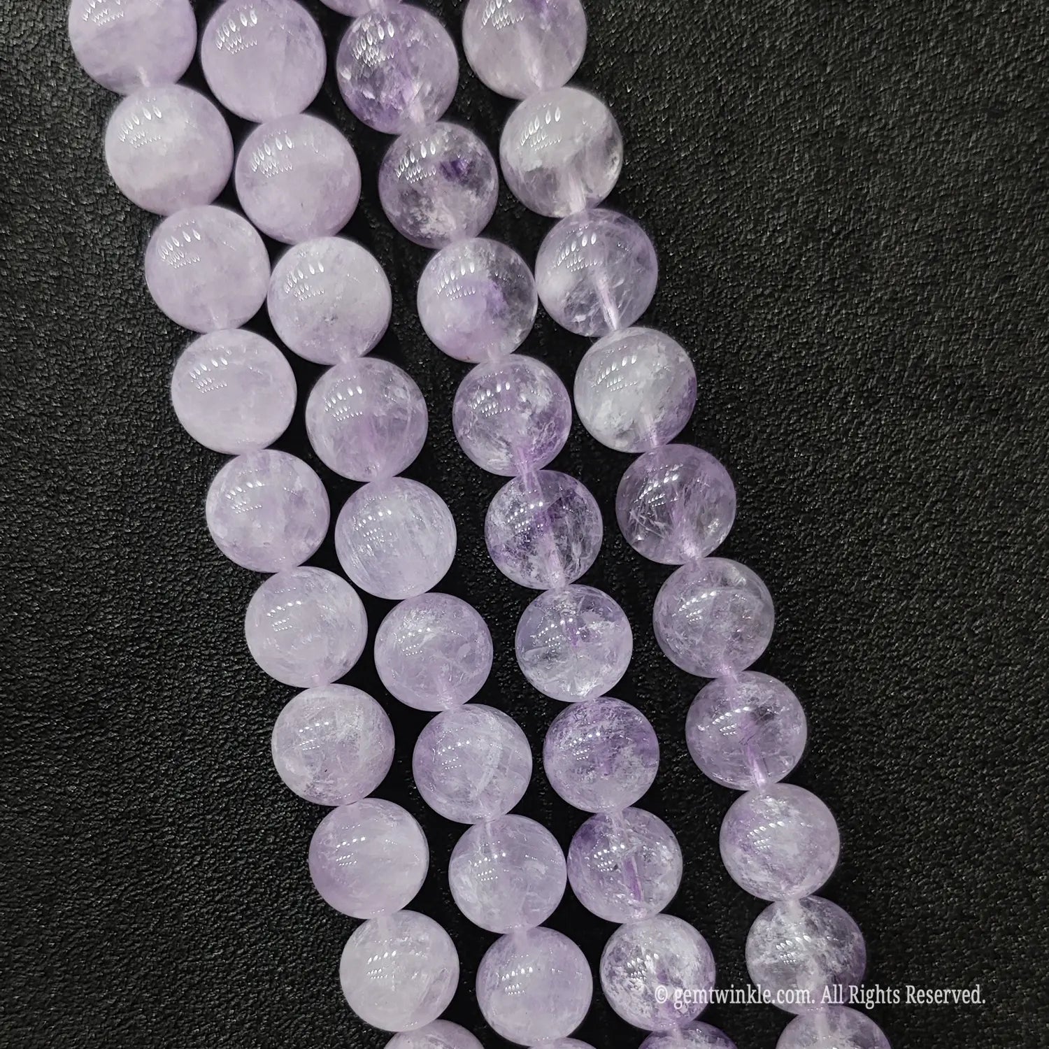 Three strands of soft purple lavender amethyst crystal beads showcasing delicate milky translucent texture