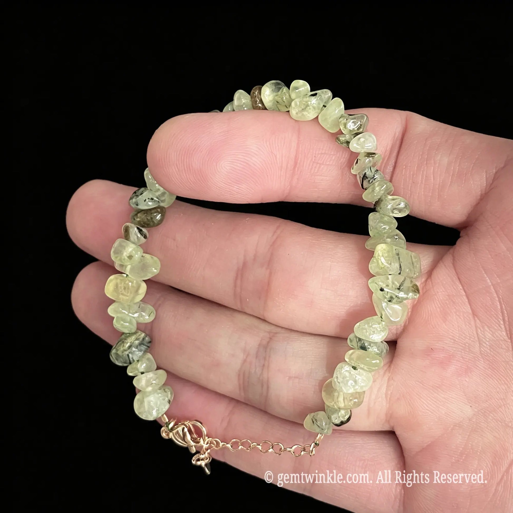 soft green prehnite raw chip nugget bracelet held on hand showing translucent gemstone beads