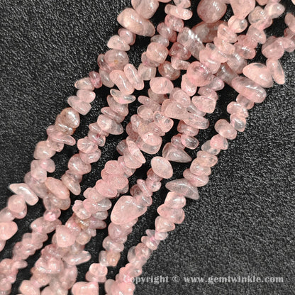Close up view of tumbled speckled pink strawberry quartz freeform nugget chip beads