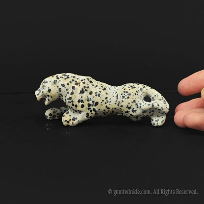 Detailed right side view of a crouching dalmatian jasper leopard statue highlighting smooth polished finish for retail displays