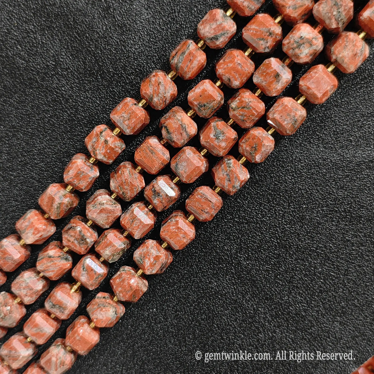 Close up view showing the unique natural speckles and geometric cut of red sesame jasper blocks
