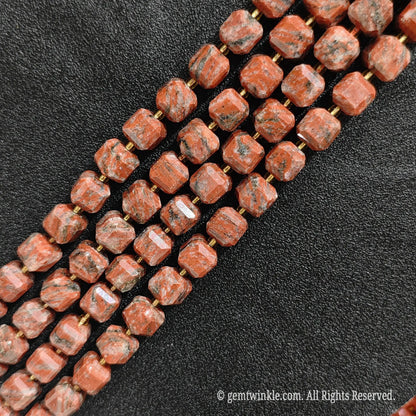 Close up view showing the unique natural speckles and geometric cut of red sesame jasper blocks