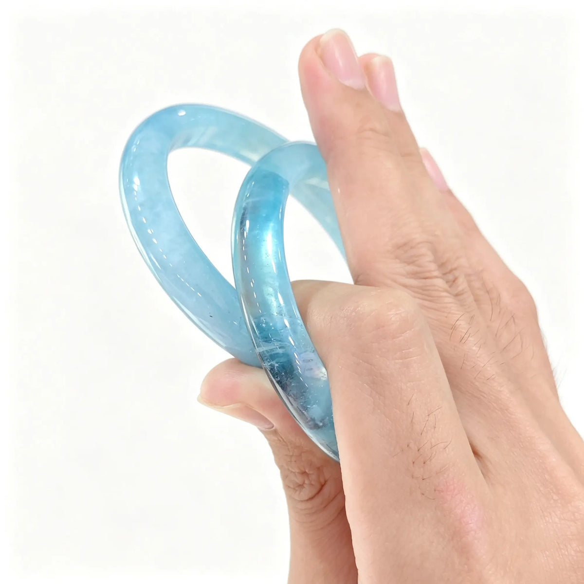 Pair of authentic carved Aquamarine bangles showing stabilized ice blue quartz translucency
