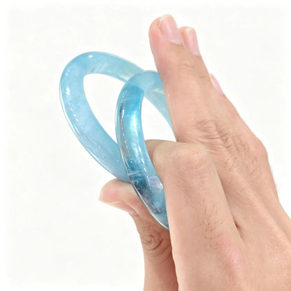 Pair of authentic carved Aquamarine bangles showing stabilized ice blue quartz translucency
