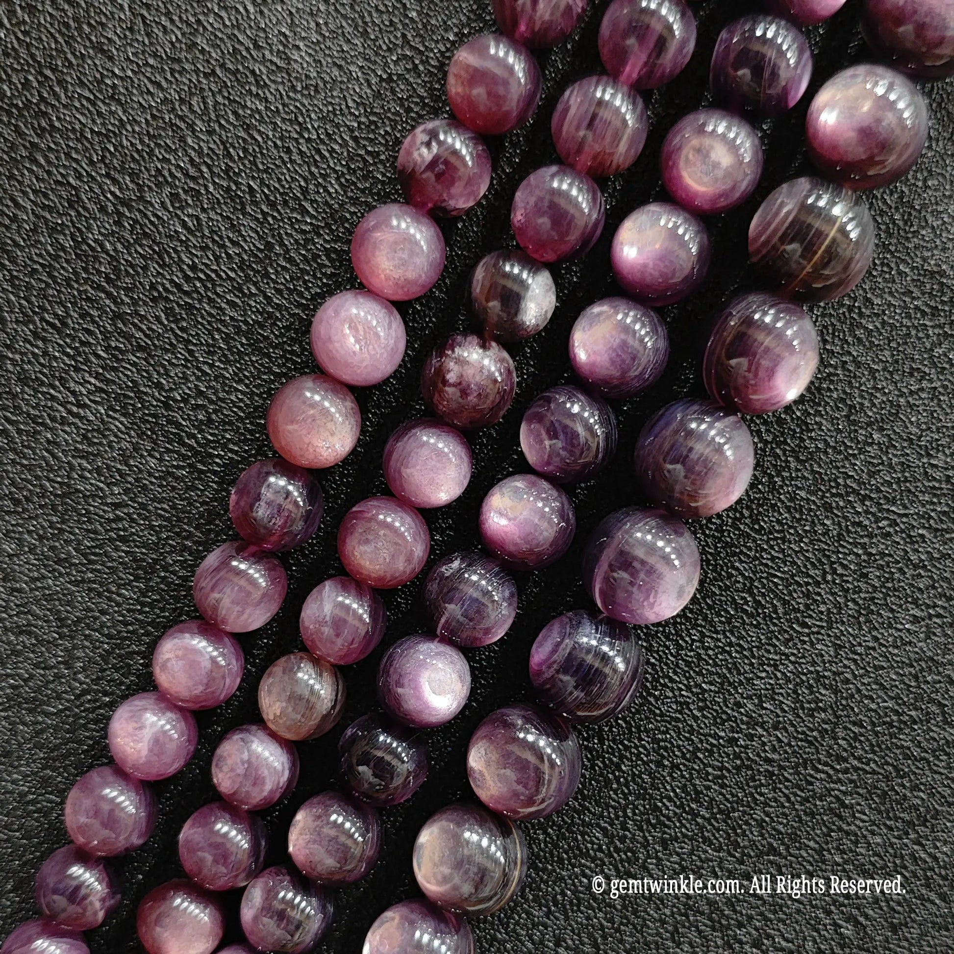 Close up of stabilized purple lepidolite crystal beads highlighting the unique glittering mica sheets from image_11359b.jpg